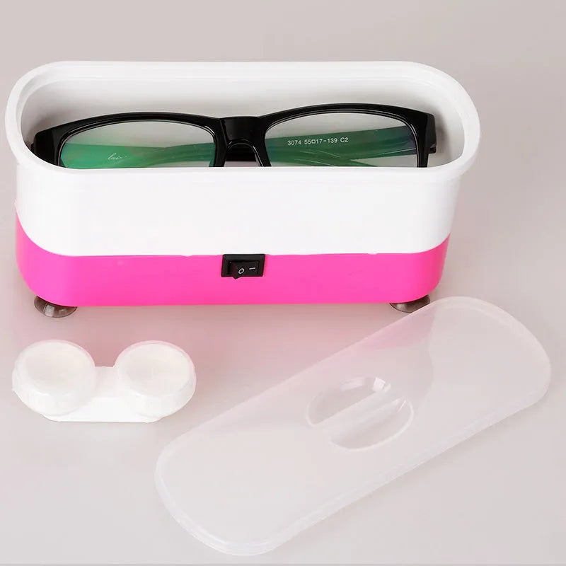 Analog ultrasonic cleaner in blue plastic casing with battery compartment and suction cups for cleaning glasses and contact lenses