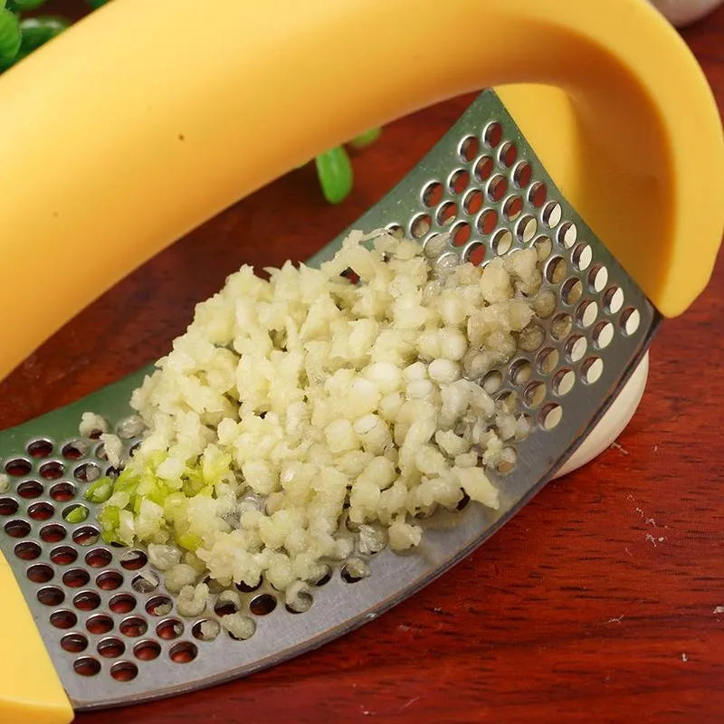 Stainless steel manual garlic press with ergonomic non-slip handle in assorted colours