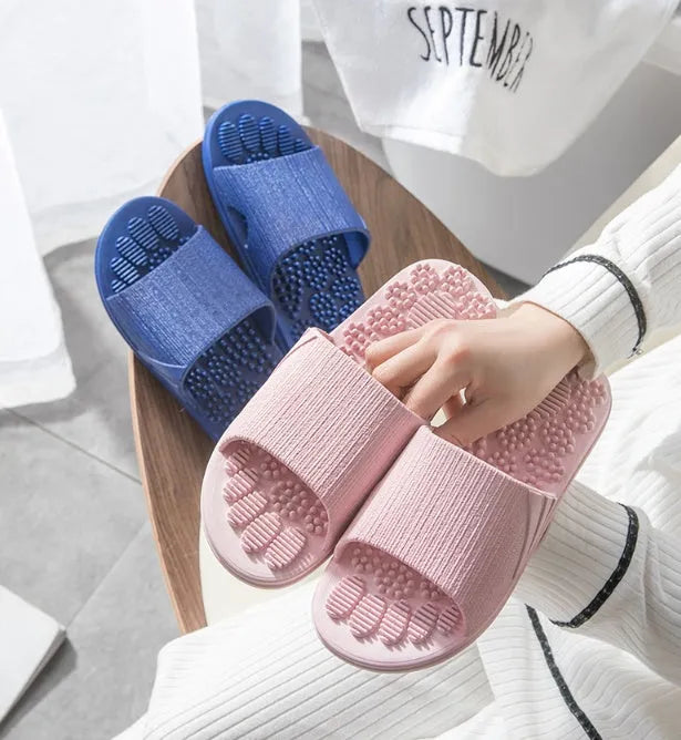 Pair of reflexology foot massage slippers with 3D acupressure particles, blue colour, on a light background