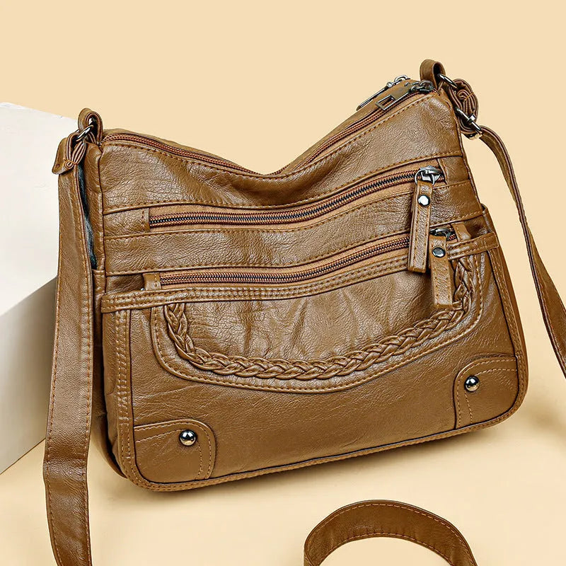 Soft PU messenger bag in horizontal square shape with multiple pockets and sewing thread detailing