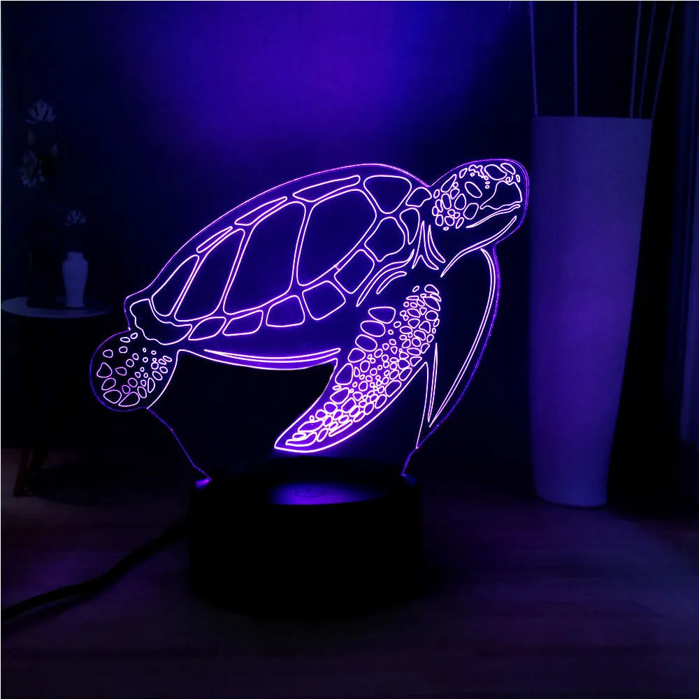 3D clear acrylic turtle-shaped LED night light with multicolour glow on a dark surface.