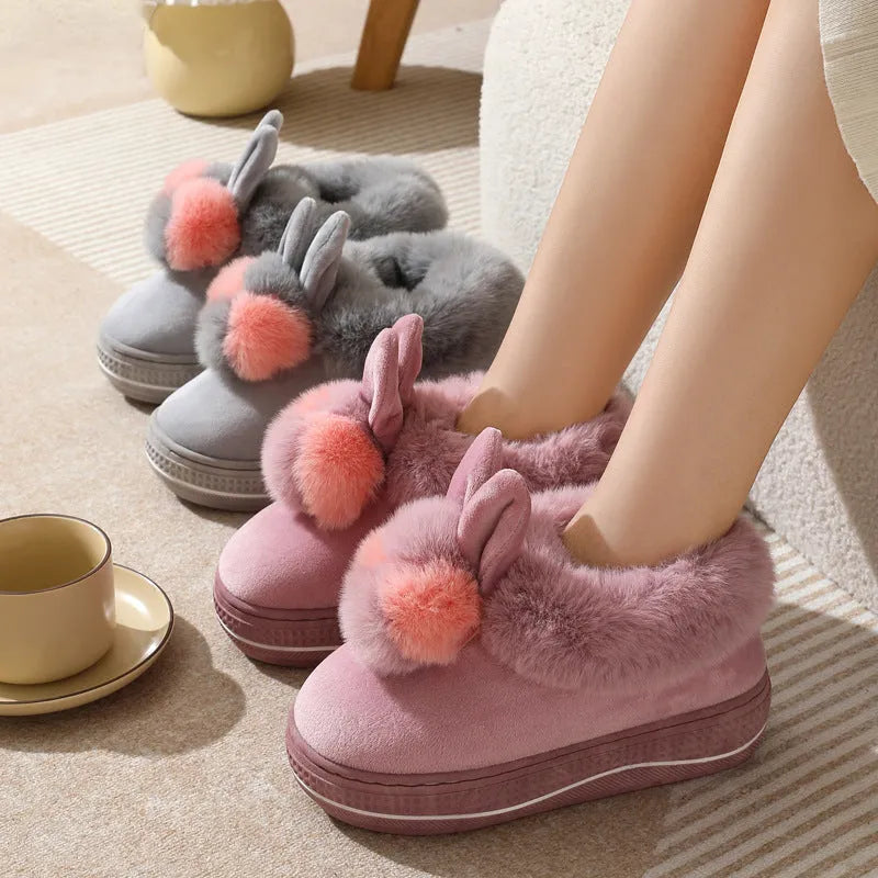 A pair of thick-soled high heel slippers in plush material with a TPR sole, shown in grey colour.