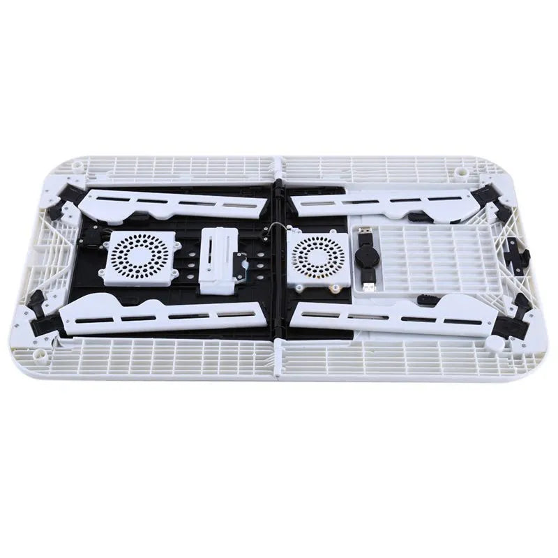White folding computer desk bed with adjustable legs and tilting baseplate, open on a bed showing dual heat vents