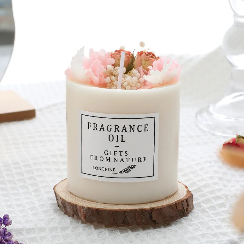 Dried flower decor scented candle in glass jar with botanical elements visible within wax