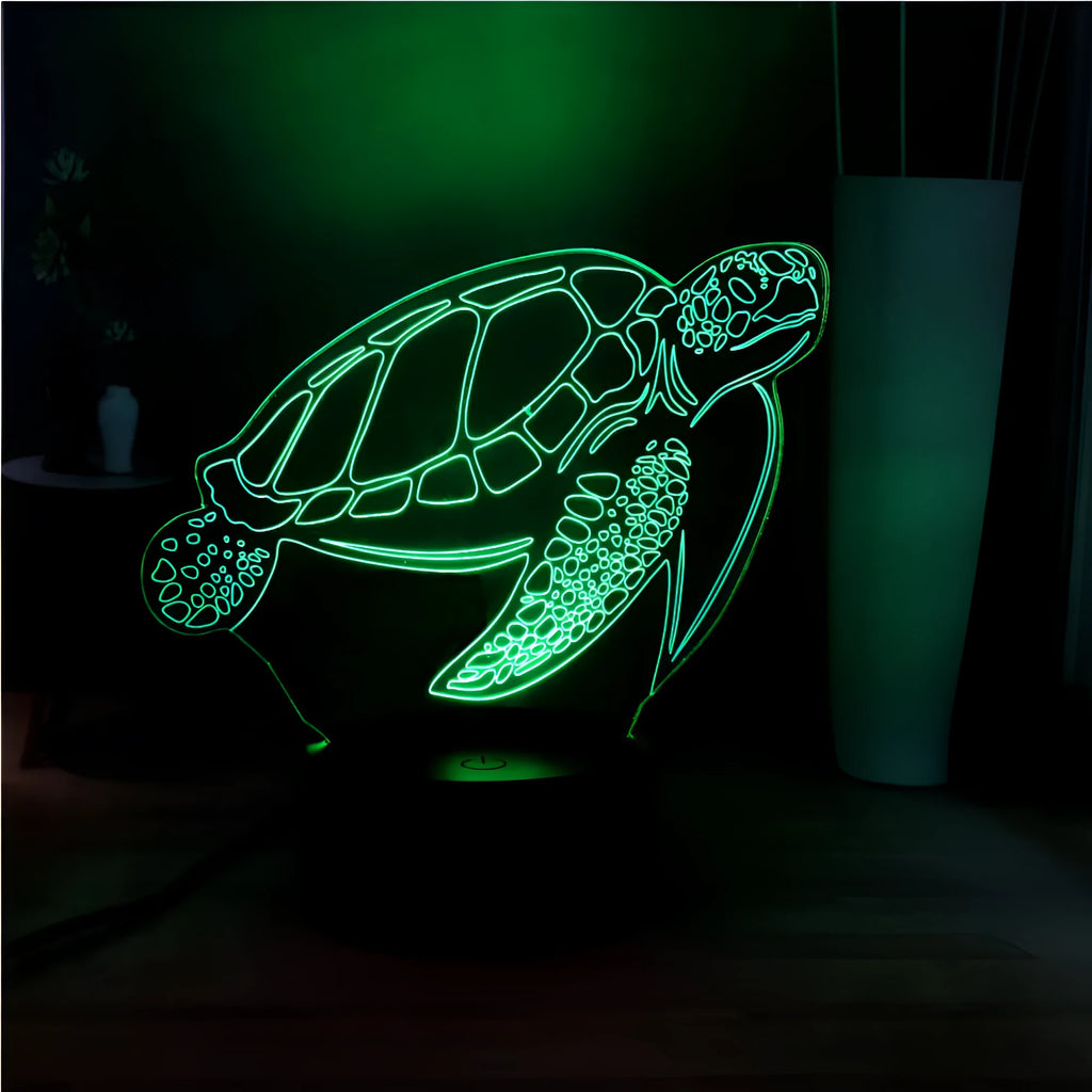 3D clear acrylic turtle-shaped LED night light with multicolour glow on a dark surface.