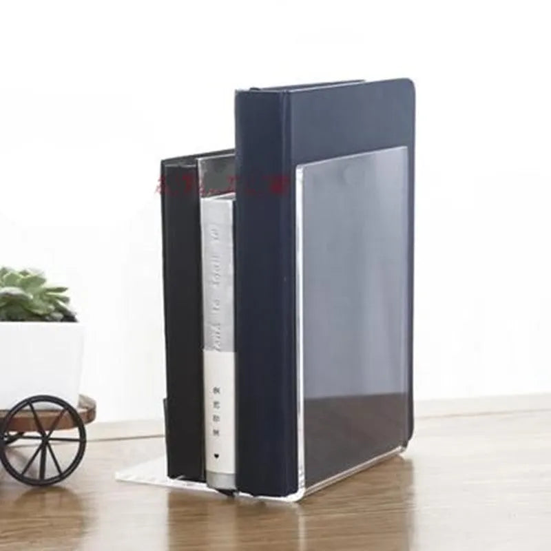 Transparent acrylic bookshelf displaying organised books on a study desk