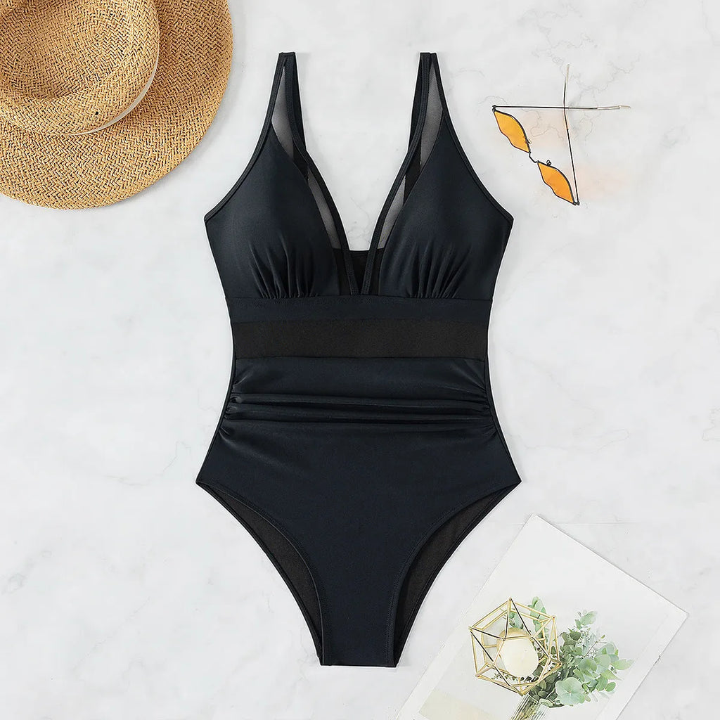 Black women's one-piece swimsuit with halter neck and briefs style.