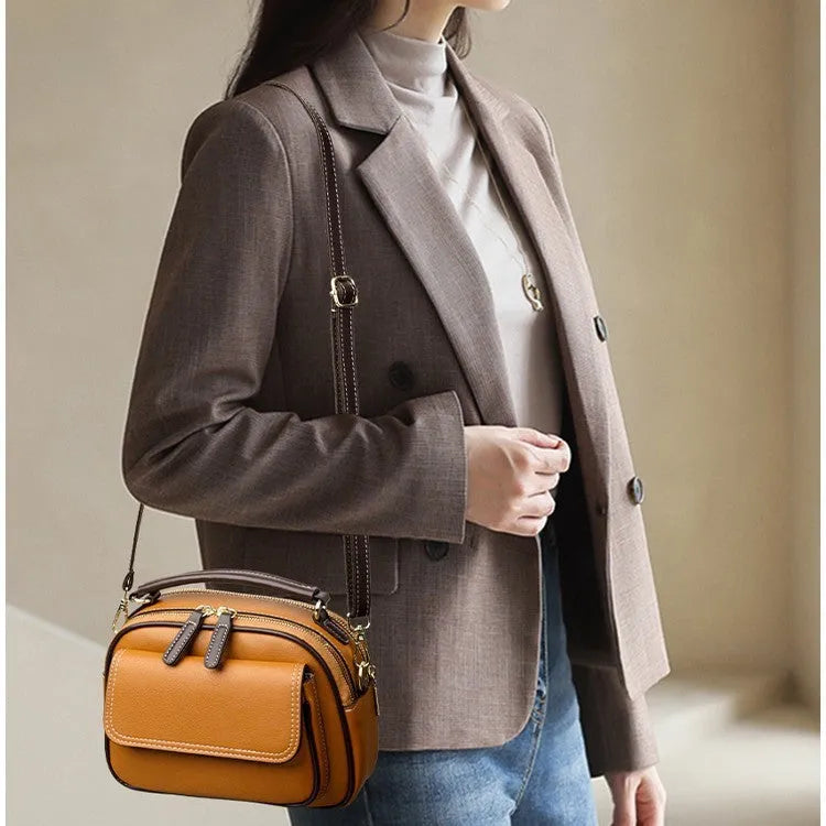 Women's black PU leather cross-body shoulder bag showing horizontal square shape and double straps