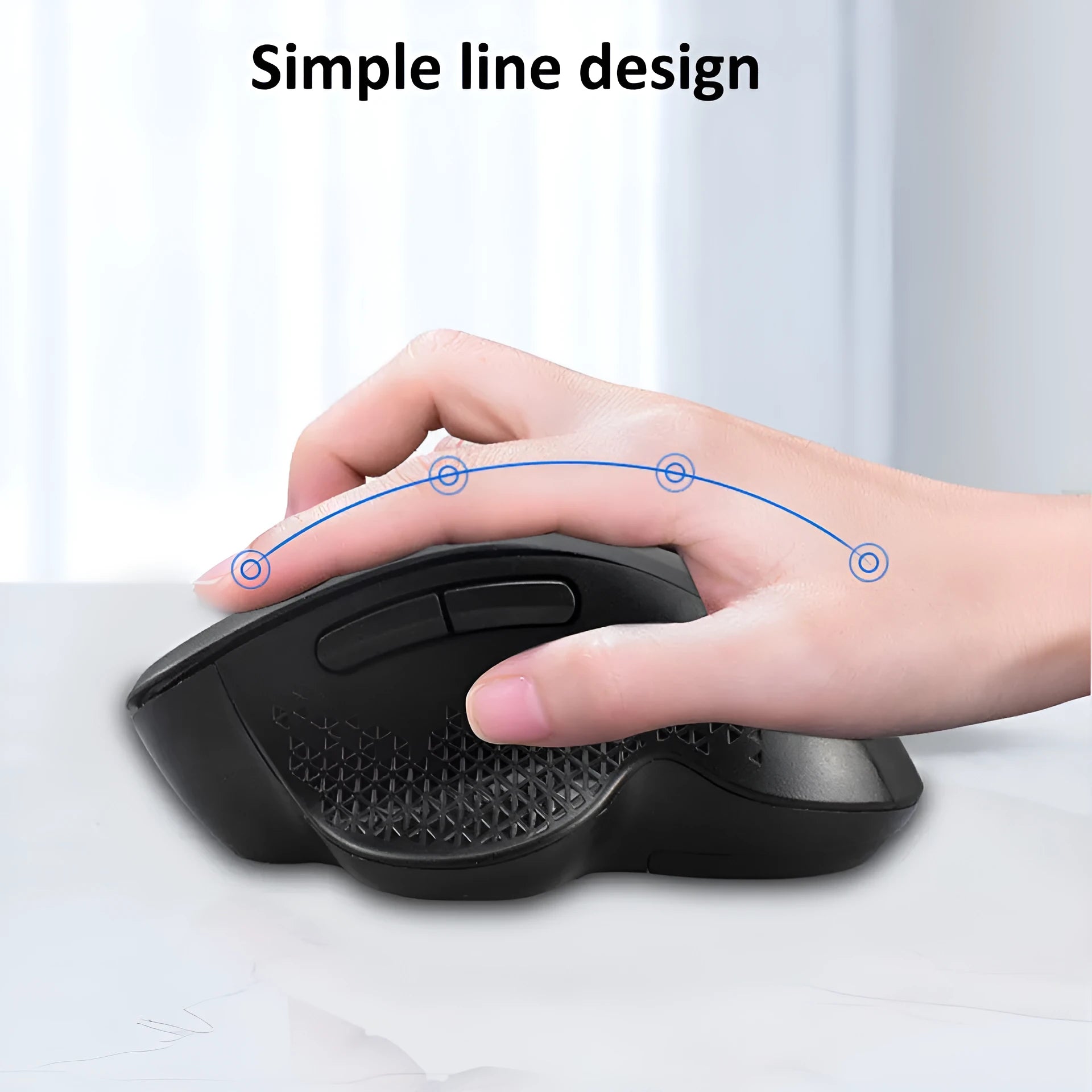 Grey wireless optical mouse with USB charging cable next to laptop computer