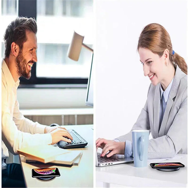 Black wireless charging pad on table with phone charging and blue LED indicator light