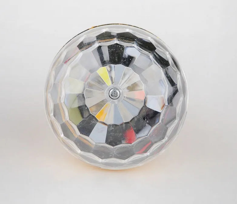 LED colourful rotating magic ball light with 6 RGB beads and lamp holder on a table