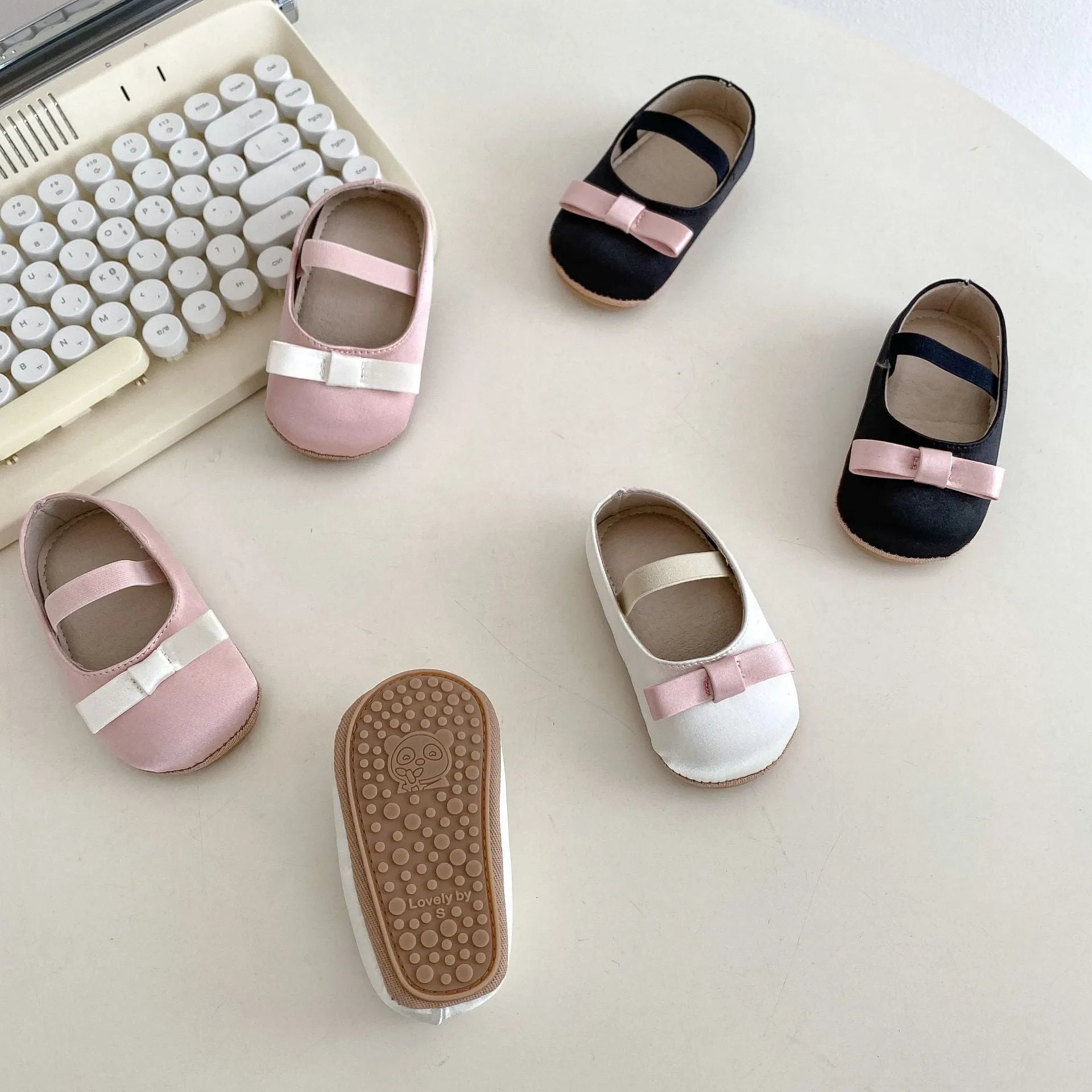 Cute baby butterfly knot shoes in solid colour with bow detail, breathable cloth and rubber sole