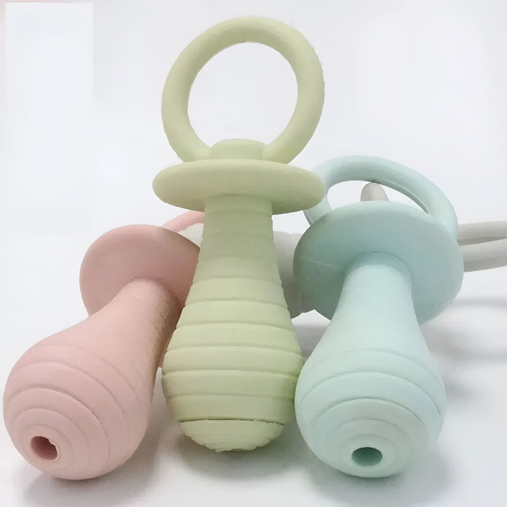 Set of four coloured TPR rubber pacifier chew toys for puppies and kittens on a white background.
