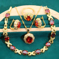 Gold plated necklace, earrings, bracelet, and ring set with blue cubic zirconia stones.