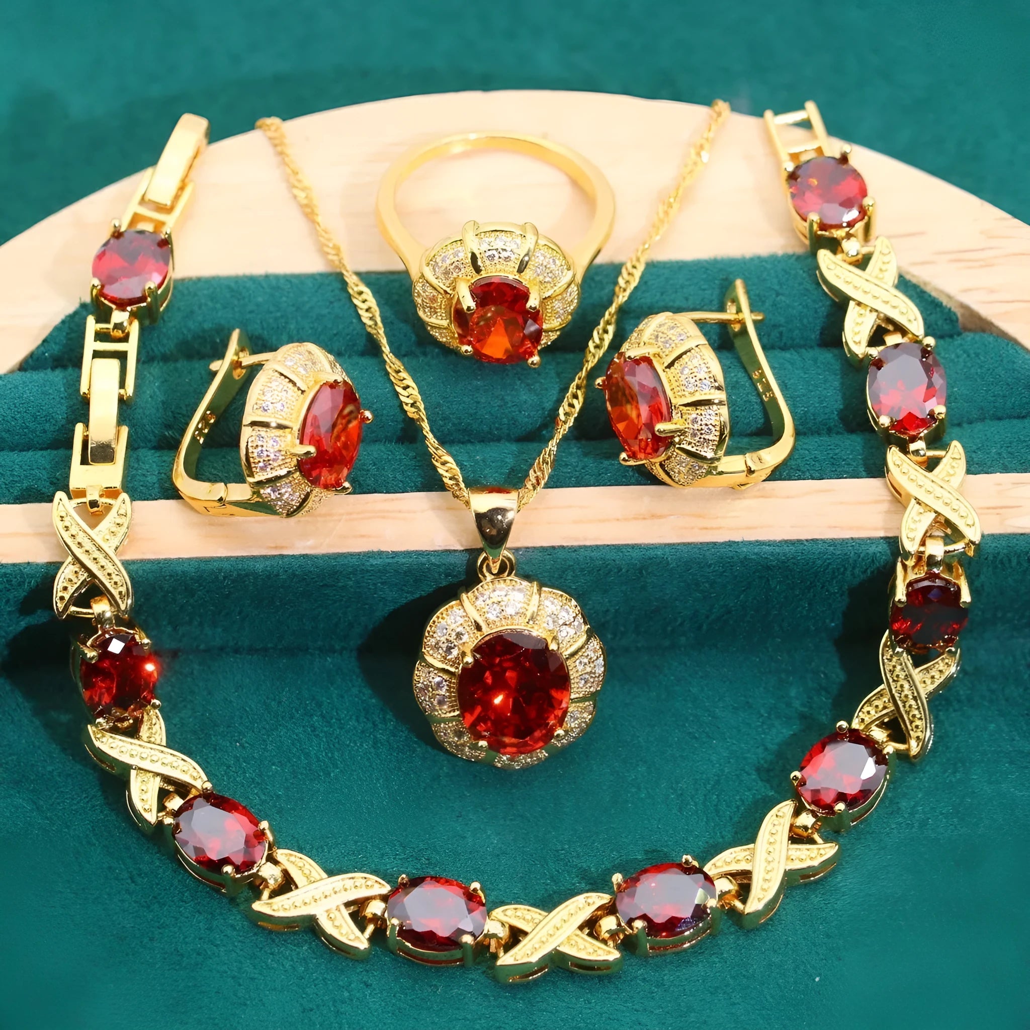 Gold plated necklace, earrings, bracelet, and ring set with blue cubic zirconia stones.