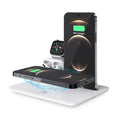 Black desktop wireless charger with phone on pad, watch and headphone cables connected.