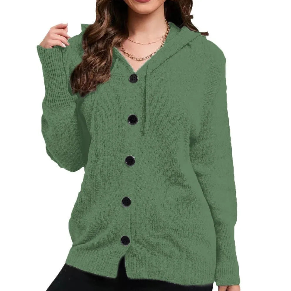 A woman wearing a loose-fit, solid-colour hooded cotton cardigan sweater.