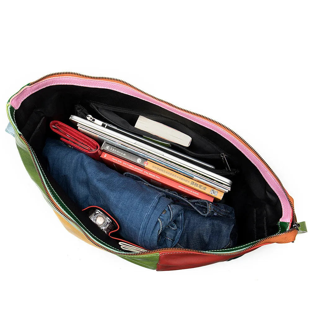 Brown cowhide leather crossbody travel bag open to show space for a 15-inch laptop and A4 documents.