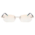 Diamond-cut metal reading glasses with tan frame and black lenses on a plain background