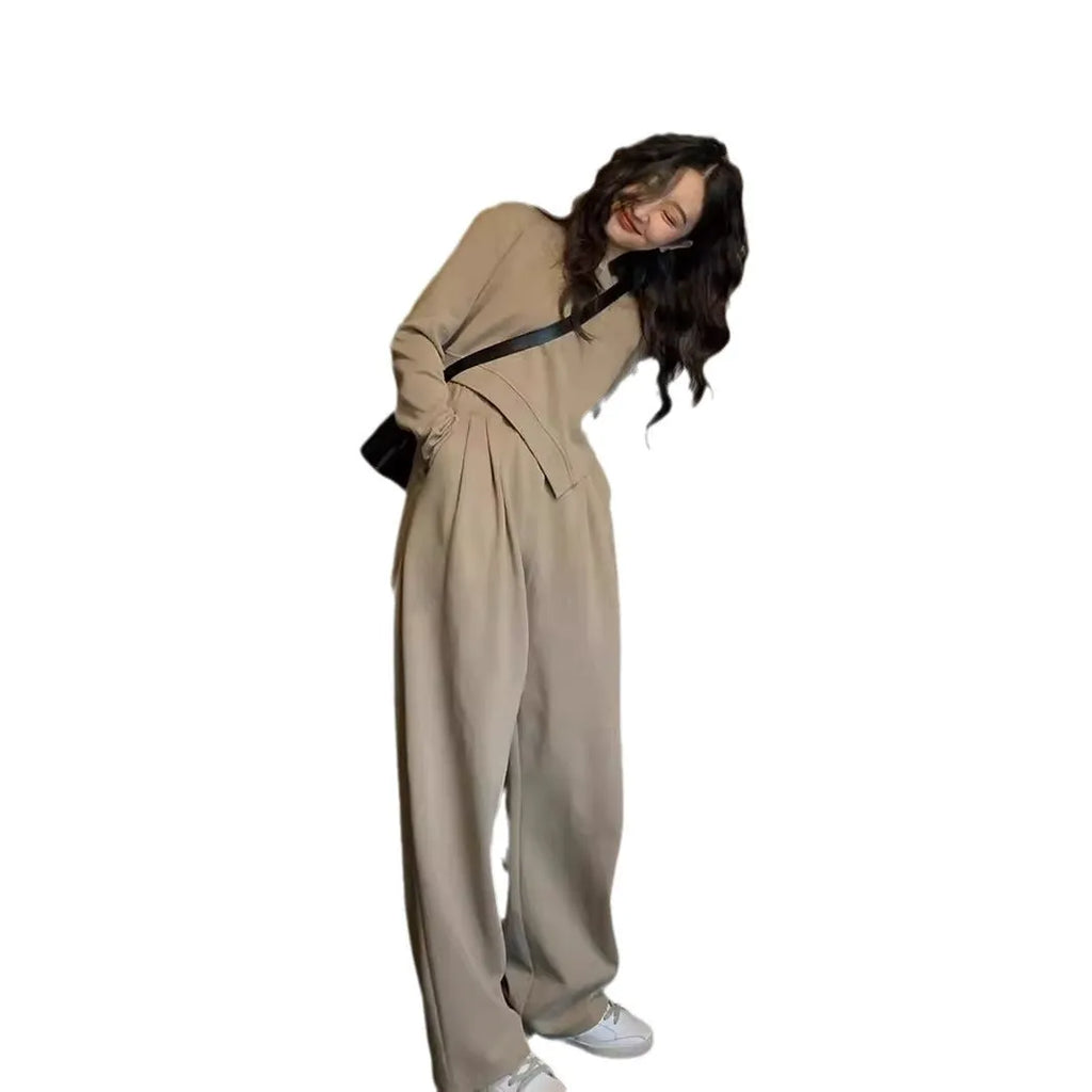 Women's khaki coloured loose-fit casual sports suit with long sleeves and trousers on a hanger.