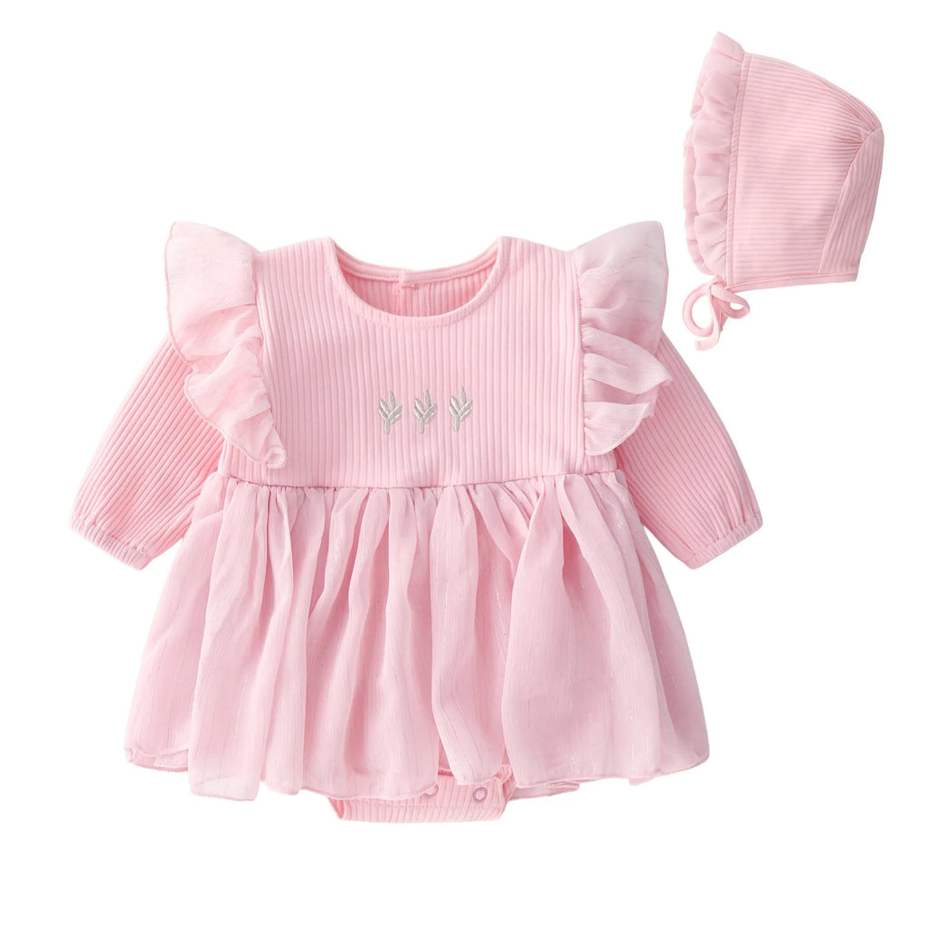 Baby girl wearing a fluffy cotton princess dress in pink, available in red and white, sizes 59cm to 80cm.