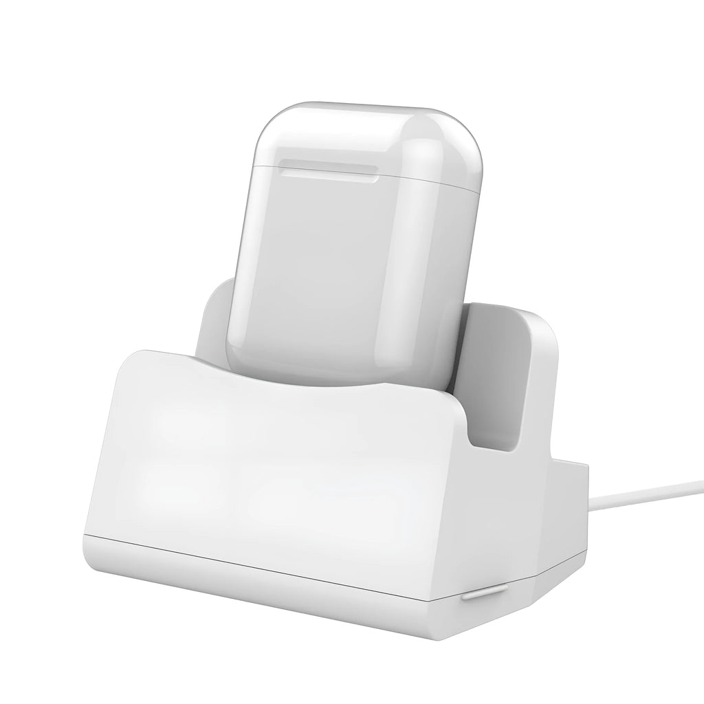 White headphone charging base station on a desk, holding a pair of over-ear headphones.