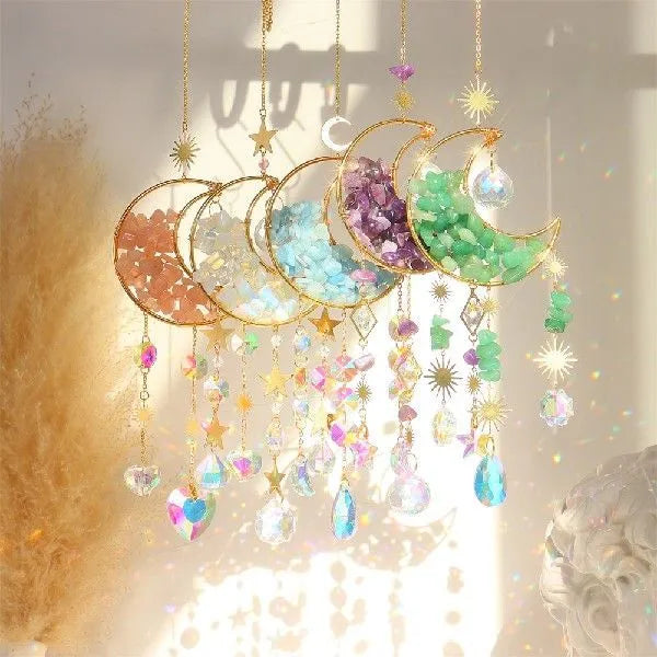 K9 crystal moon-shaped pendant on a cord for hanging in a car interior.