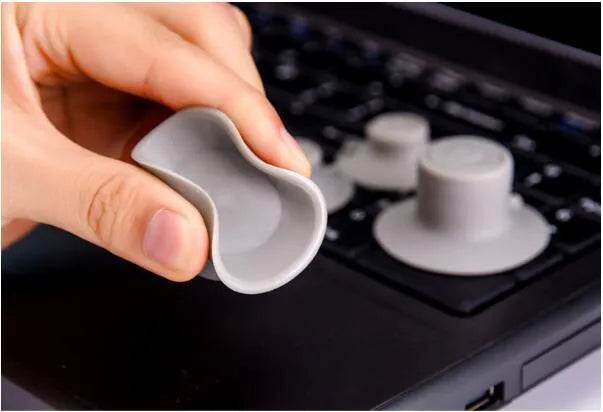 Grey durable plastic laptop cooling stand with two large and two small non-slip pads.