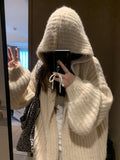 Woman wearing a dark grey retro knit Maillard pattern hooded cardigan