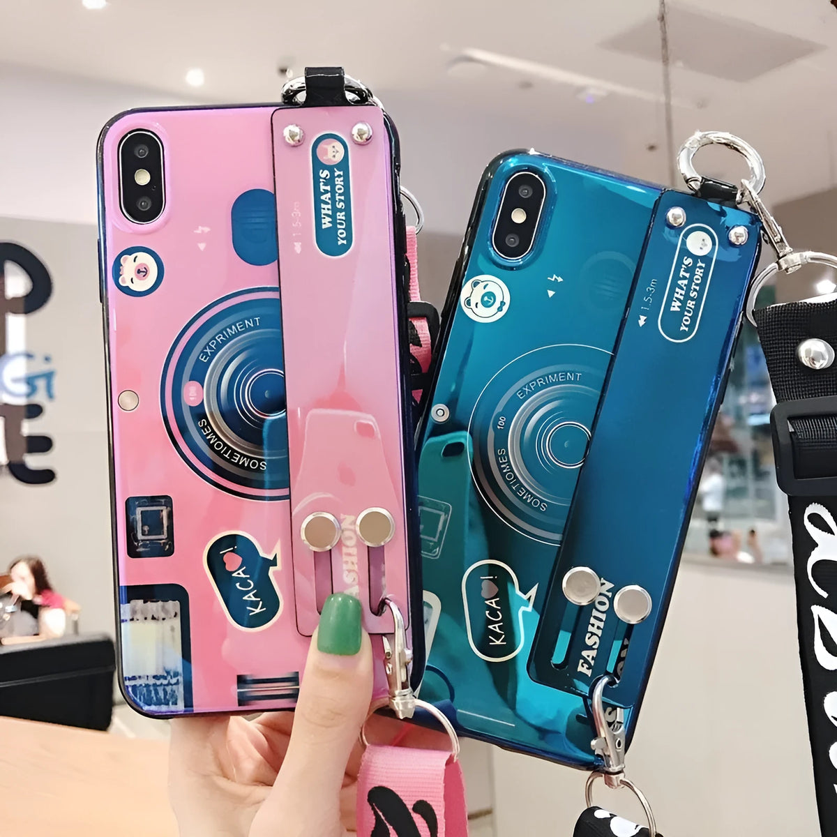 TPU iPhone case with retro camera design in blue or pink, back cover style, optional wrist strap.