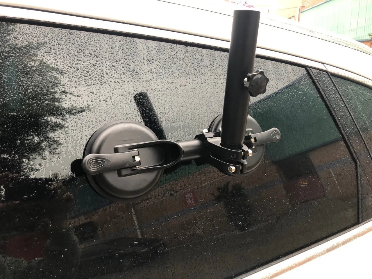 Black off-road car windscreen sucker mount with a large round rubber suction cup for flagpoles.