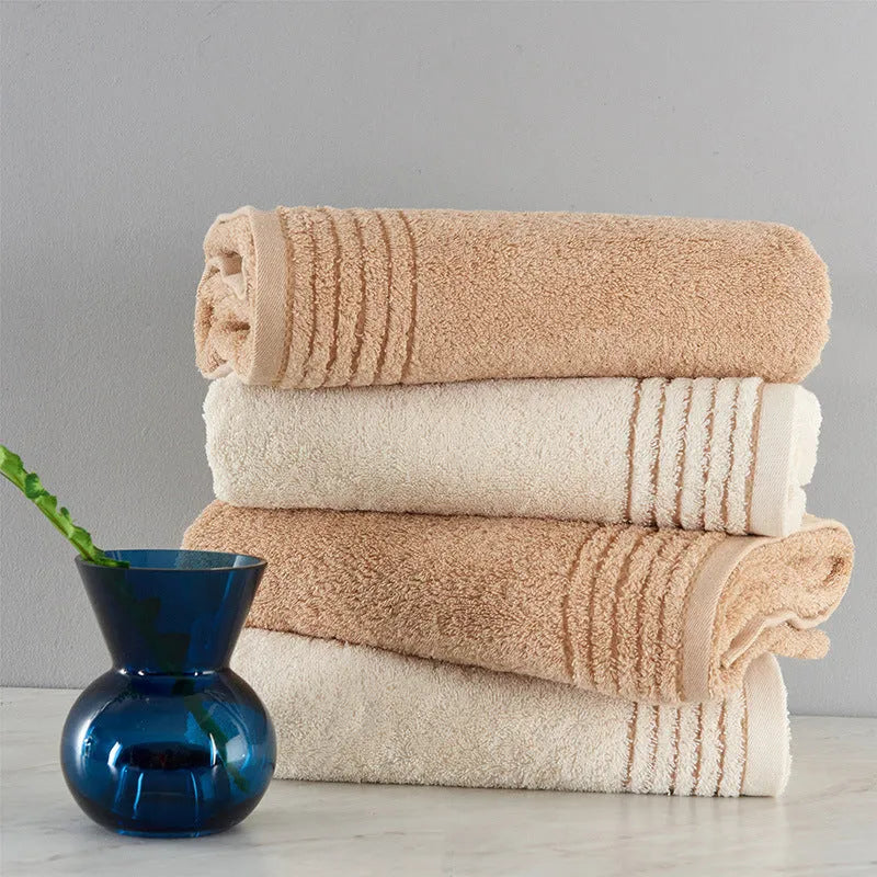 Cotton towel set showing bath, hand and face towels in beige or brown colours