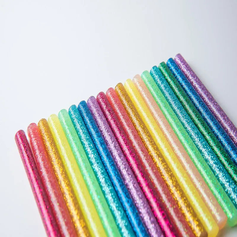 Pack of 10 colorful hot melt glue sticks with gold leaf and luminous effects, 7.2mm and 11.2mm diameters, in various lengths.