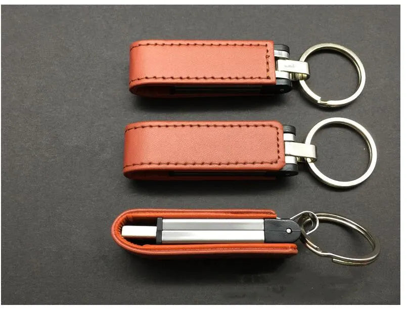 Leather USB 2.0 flash drive keychain in brown with keyring attachment on a white background