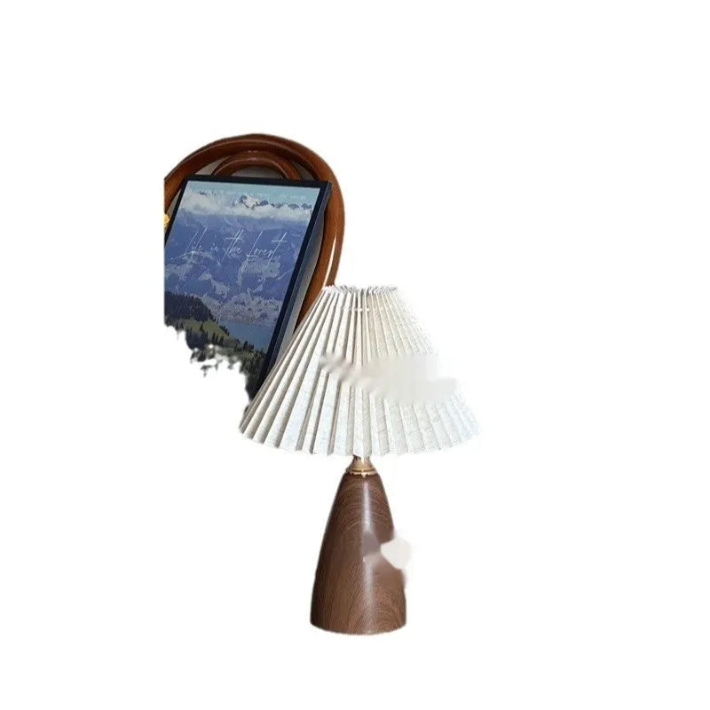 Nordic style ceramic table lamp with a pleated fabric shade on a bedside table