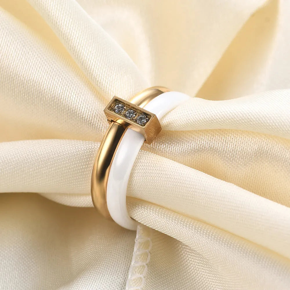 Geometric ceramic women's ring with glossy stitching and inlaid zirconium detail, shown in steel black.
