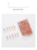 Rose gold heart-shaped metal paper clips, 28mm size, shown in a pack of 100.