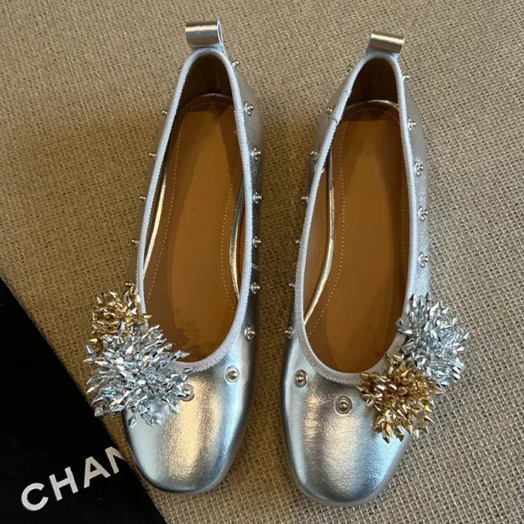 Women's silver Mary Jane flat shoes with a buckle strap and sheepskin upper.