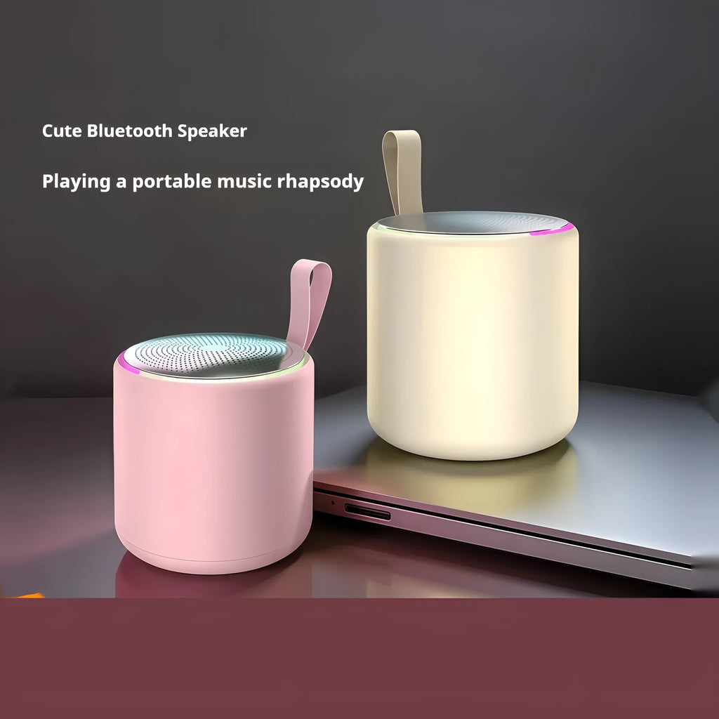 Bluetooth mini portable speaker in beige, front view, with compact design and visible speaker grille