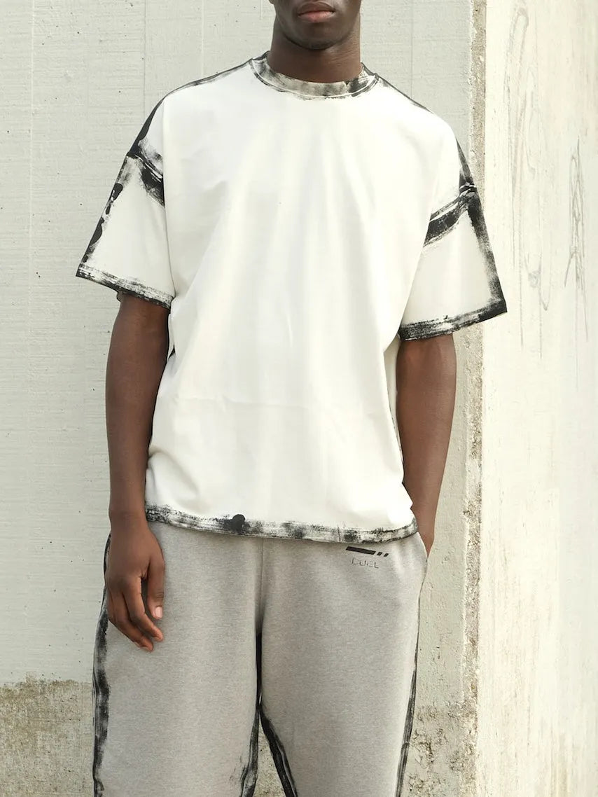 Women's white short sleeve top with draped design and printed pattern in casual style