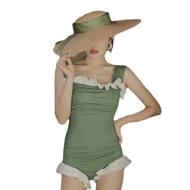 Black high-waisted one-piece swimsuit on a mannequin, showing quick-dry fabric and slimming cut.