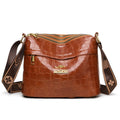 Brown cross body bag with multiple compartments and horizontal suitcase shape