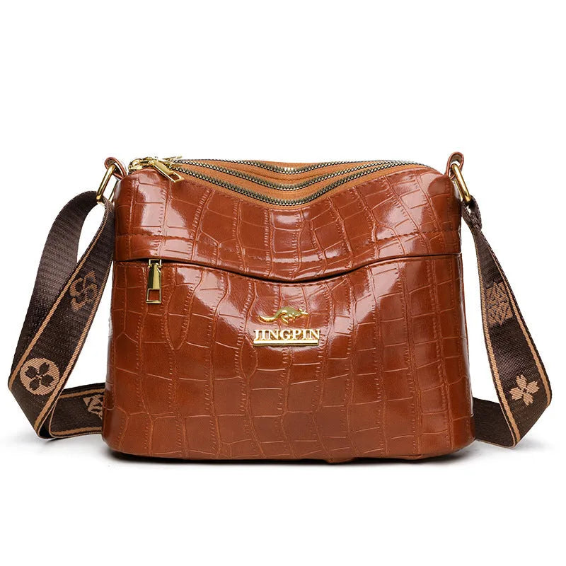 Brown cross body bag with multiple compartments and horizontal suitcase shape