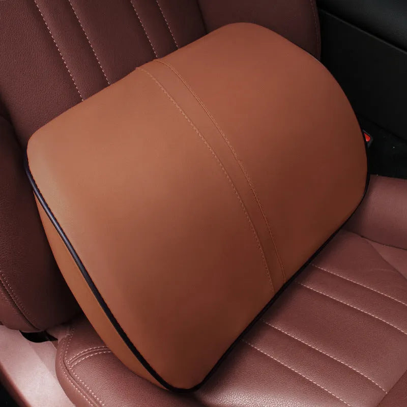 Car seat cushion headrest with memory foam interior and leather exterior in solid colour
