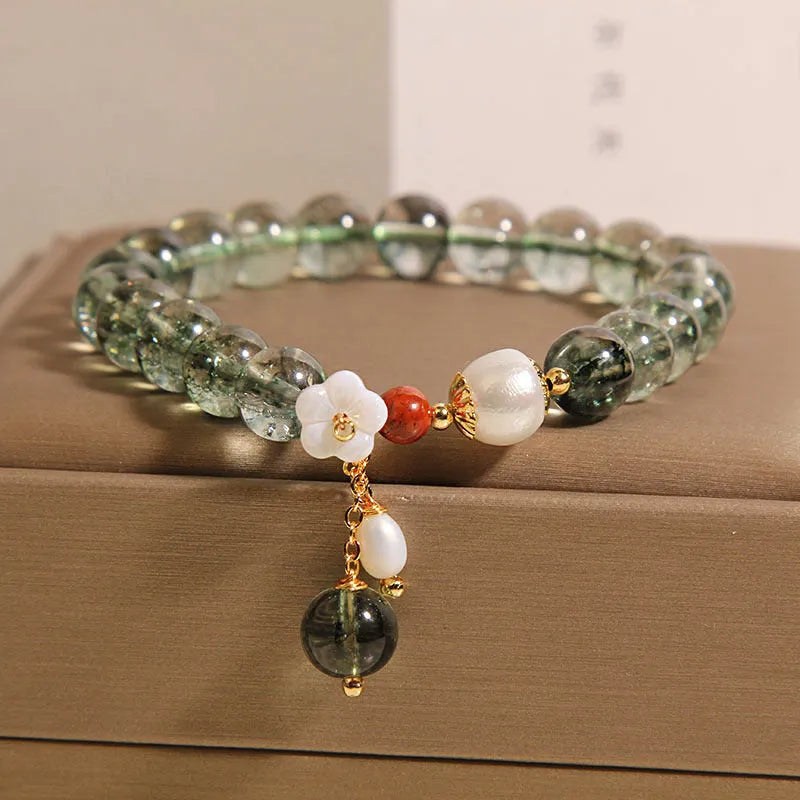 Green phantom quartz crystal bracelet with Bells of Ireland and shell flower design