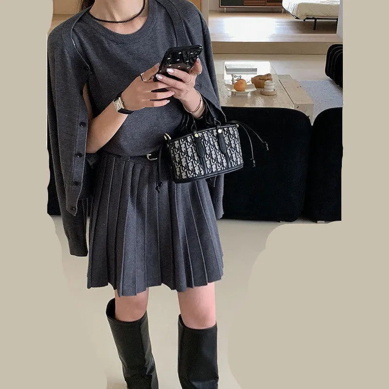 Grey art retro knitted two-piece set for women, showing a vest skirt and long-sleeved cardigan with a belt.