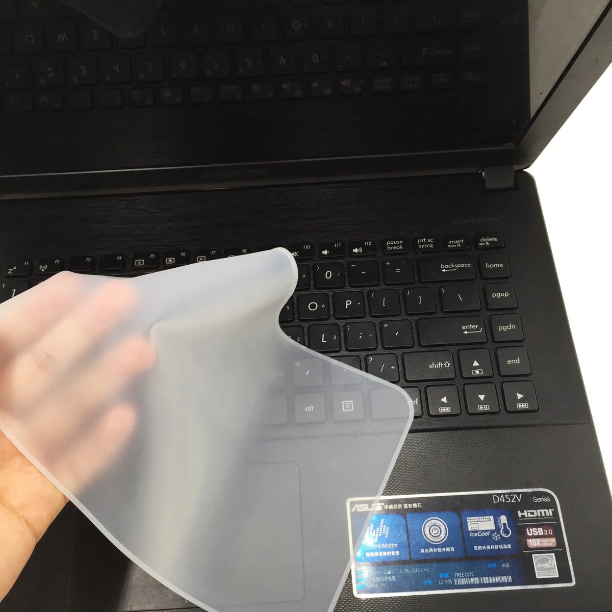 Transparent silicone keyboard dust film for laptop, showing close fit over keys