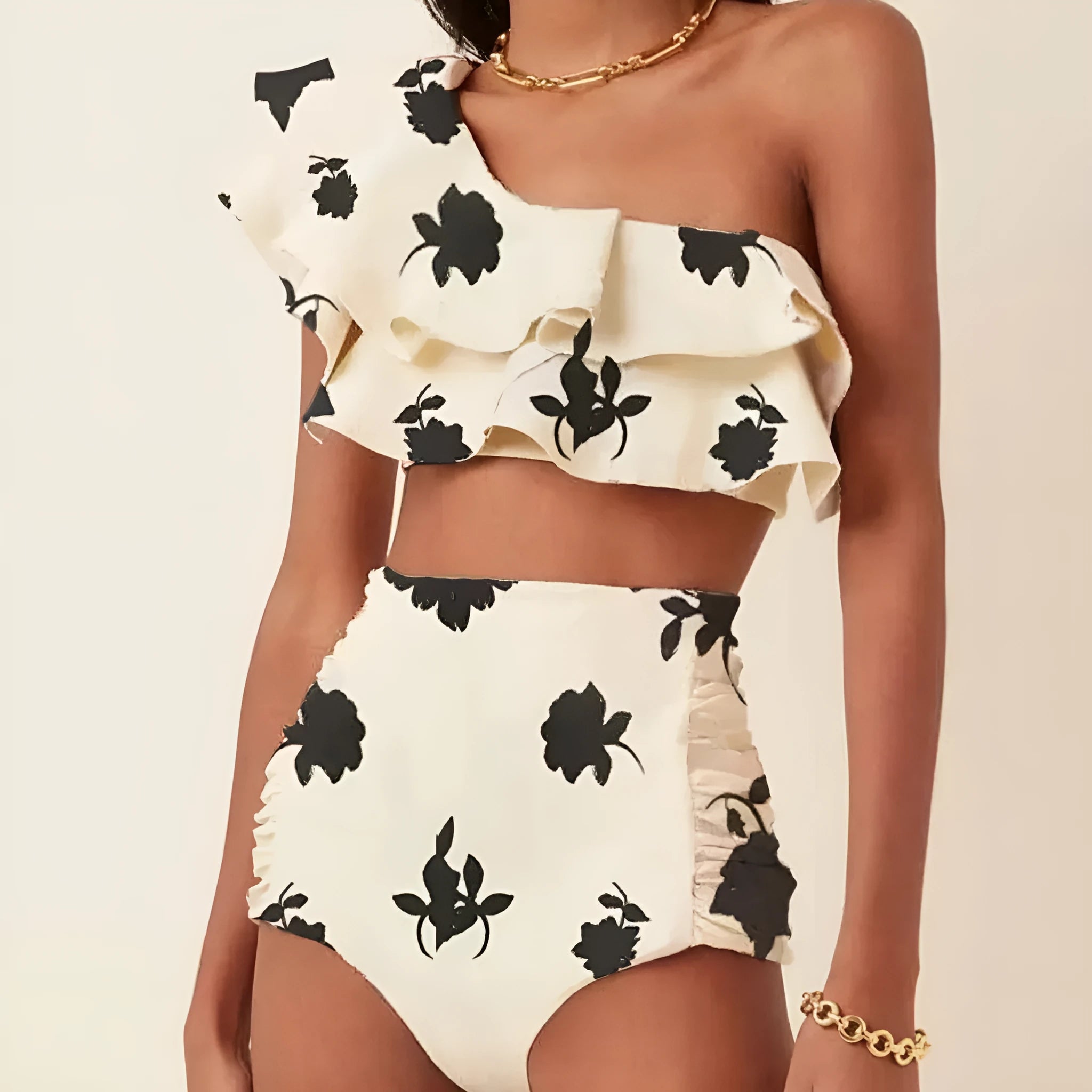 Women's high-waisted bikini set with ruffled shoulders in a striped pattern.