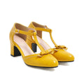Yellow women's chunky heel sandals with a buckle strap and bow detail on a hollow-out round toe.