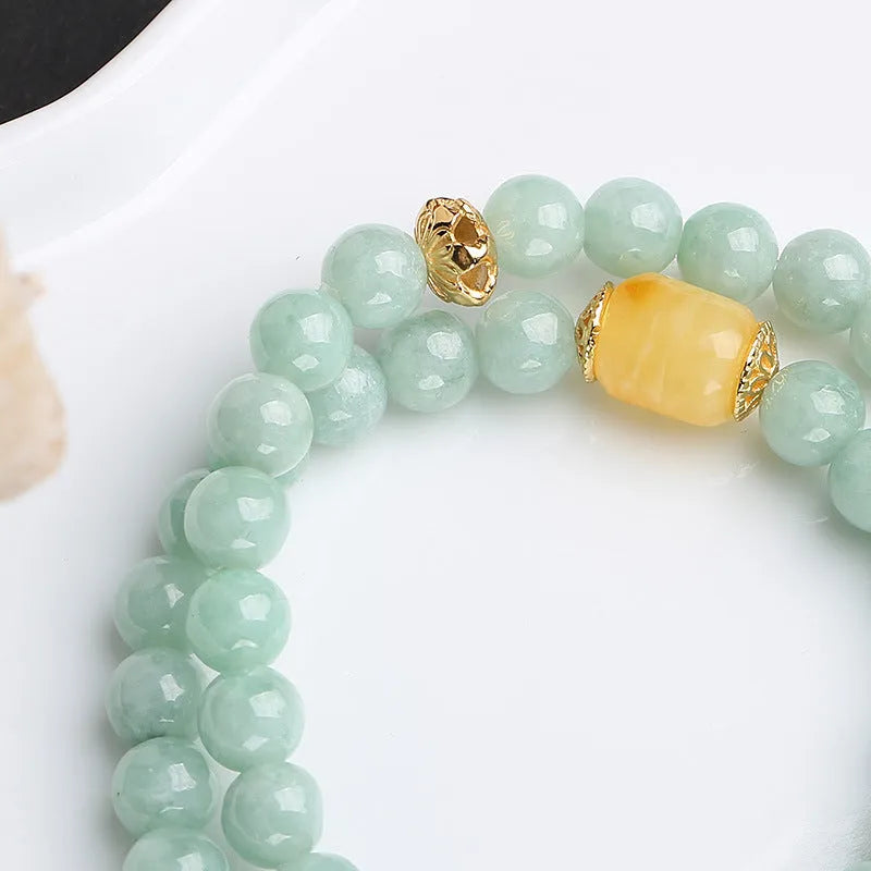 Double-layer retro bracelet with emerald jade round beads and hanging beeswax barrel beads.